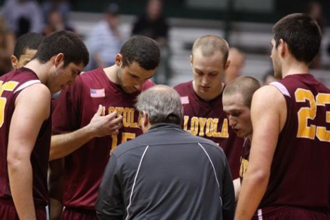 Team members huddle around head coach Michael Giorlando.