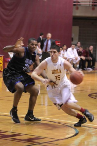 General Studies sophomore Robert Lovaglio battles it out during the Loyola game against Shorter University Friday Dec. 2. This was Loyola's first lost in The Den with a final score of 82-59.