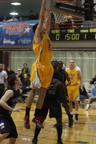 Cameron Cates, managment senior, goes for the dunk against Spring Hill college on Thursday Jan. 12 at the Den. Cameron scored 13 points that helped Loyola win 67-65.