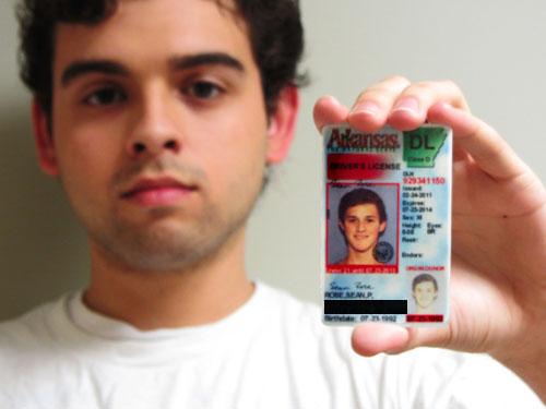 General studies freshman Agustin Crespo holds up a different student’s drivers license. Many people try to use stolen identification to pass as their own. 