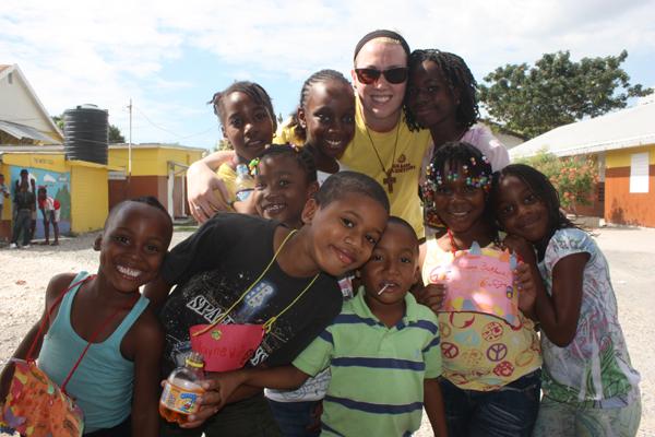 Elizabeth Collyer, psychology/ pre-med junior, stand with children from the Jamaica Winter Camp program. Collyer and other students spent their winter breaks in Jamaica, lending aid to those who needed it. 