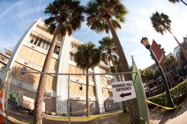 Monroe Hall is surrounded by temporary fencing as construction on the building continues Wednesday, Feb. 8. Renovations to Monroe Hall exceeded their planned budget.