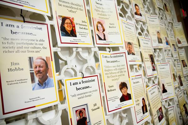 Fliers of students and faculty who support feminism line the wall by the CC's lounge in the Dana Center. The fliers were posted as part of the Women's Resource Center's efforts to raise awareness about  gender equality. 