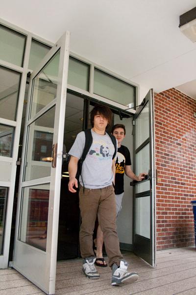 Biology Freshman Nathan Pham walks out of Biever Hall dormitory entrance Wednesday, March 7. Residents of Biever and other dormitories must participates in room draw for next year  