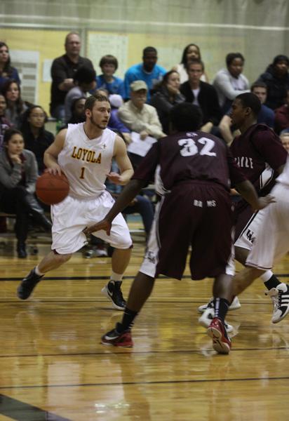 Biology freshman Kyle Simmons looks for an opening during the basketball game against University of Mobile in the Den Saturday, Feb. 25.  Simmons scored five points during this game.