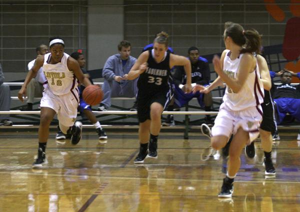 Freshman guard and psychology major Jasmine Brewer dribbles down court during the game against Faulkner University in the Den Saturday, Feb. 11.  Brewer scored 13 points during the game. 
