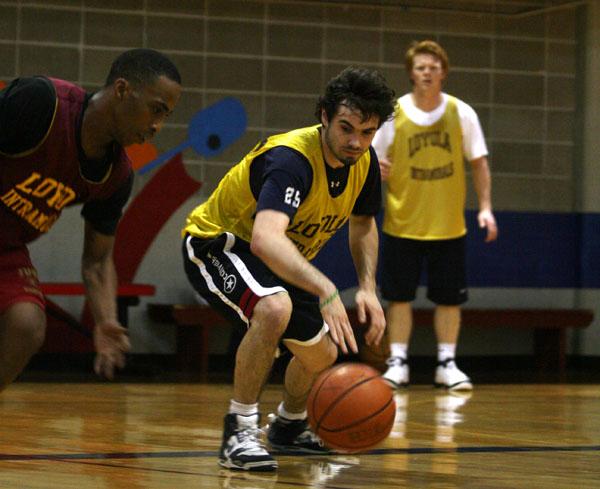 Music industry business junior Nick Serena center watches his back during an intramural basketball game Thursday, March 1. Intramural basketball will be going into its semi-final phase this weekend.