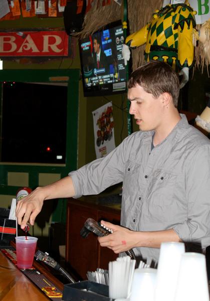 Political science junior Sam Senter bartends at The Doors. Some students at Loyola have chosen to make the most out of the night life culture by working in the city instead of partying.