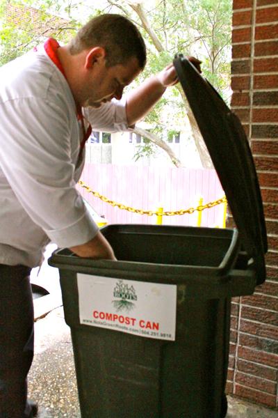 Charles Durr, Sodexo employee, places waste in the compost bin behind the Orleans Room kitchen Monday, March 19. The compost system uses spare fruit from the Orleans Room to create compost.