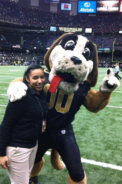 Malerie Thornton, Mass communications junior, with the New Orleans Saints mascot, Gumbo.  Thornton spends every Sunday home game on the field helping to organize events and staff. 