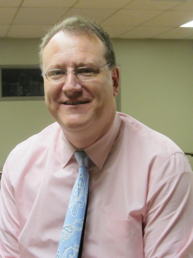 Professor Peter Burns poses for a photo after class. He has recently been recognized as one of the best professors in the nation.