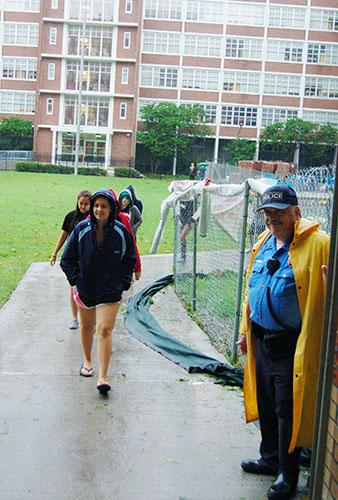 Officer Julio Alonzo guides students to the Orleans Room during Hurricane Isaac. Students staying on campus were given bagged lunches in the residential halls but were escorted to hot meals during calms in the storm.