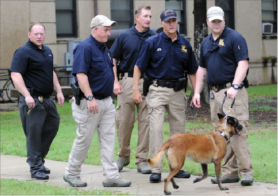 Officers talk after searching Evangeline Hall in Baton Rouge, La., where a bomb threat was received Monday, Sept. 17. Thousands of students, professors and workers were evacuated from Louisiana State University’s main campus following the threat, school officials said.