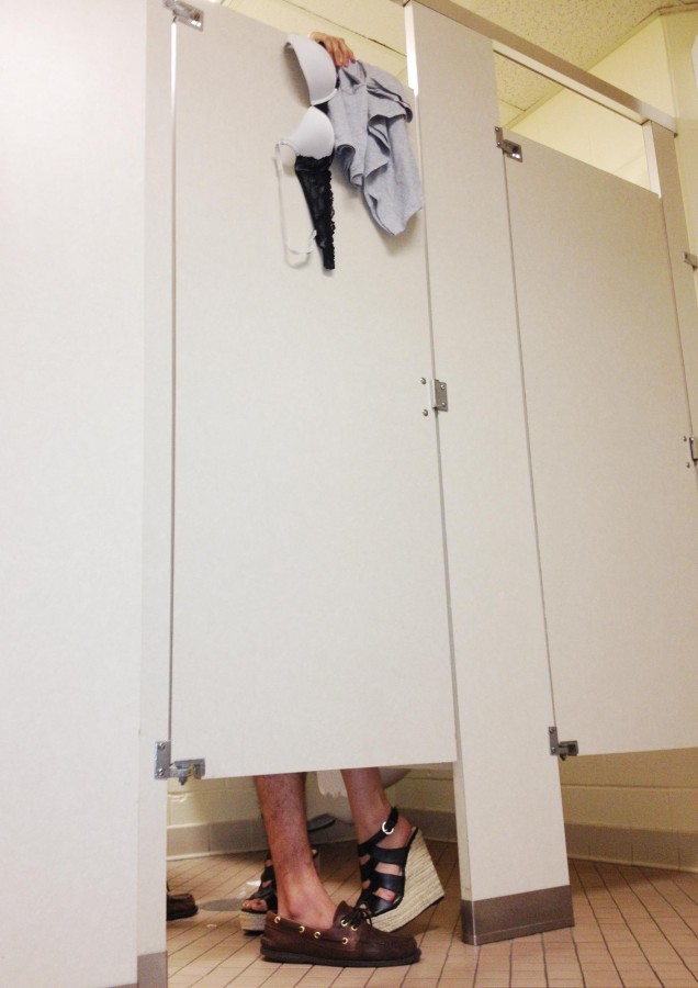 Two Loyola students pose in a bathroom stall. Some Loyola students say hook-ups are a common part of college life.