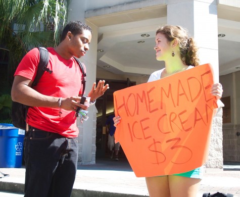 Samantha Schnetz and a customer standing outside of the Monroe Library on Friday, Oct. 5. Schnetz has been selling her homemade ice cream for the past three weeks to Loyola students.