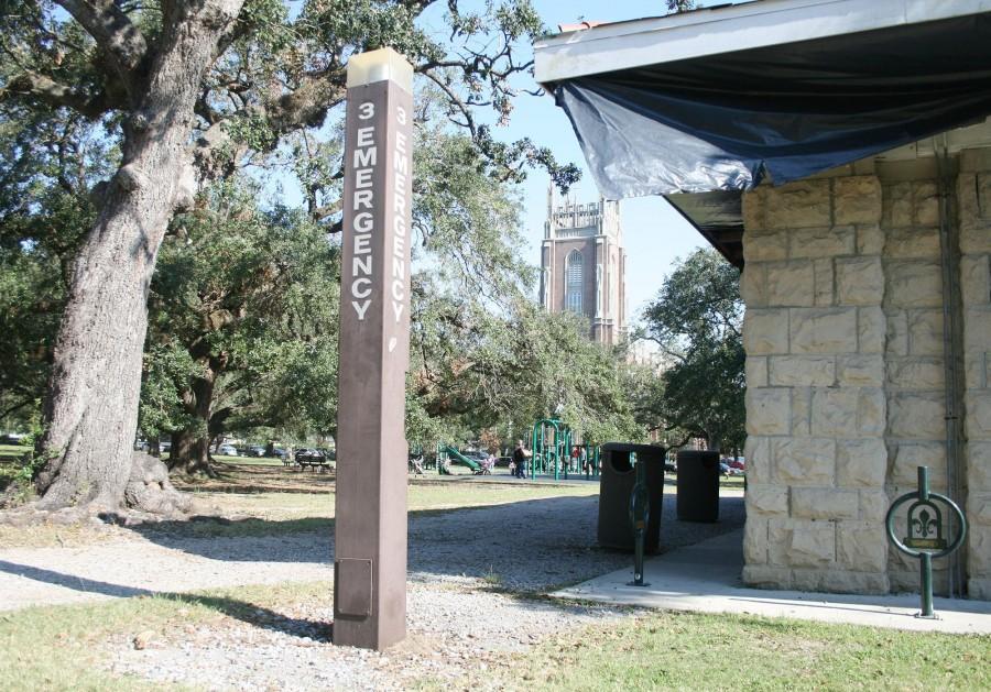 An emergency light in Audubon Park near where three students were robbed Sept. 24, with Loyola visible in the background. three men were arrested the next day.