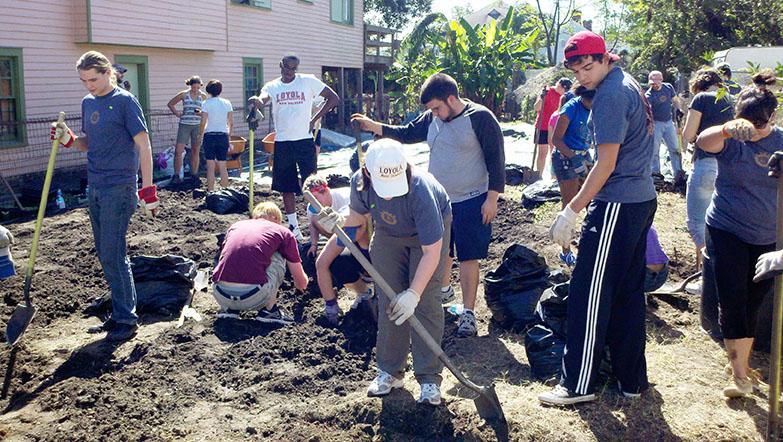 Students and alumni help dig and renew the soil on a garden for the New Orleans Food & Farm Network, which aims to promote health in community gardens. The organization began in 2002 to encourage sustanibility.