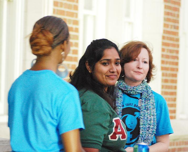 Jackie Joseph, political science junior, stands between Karen Reichard, director of Loyola’s Women’s Resource Center, and Nicole Tinson from Dillard University after telling her story at the 21st annual Take Back the Night. Several dozen Loyola, Tulane and Dillard students attended the march against rape.