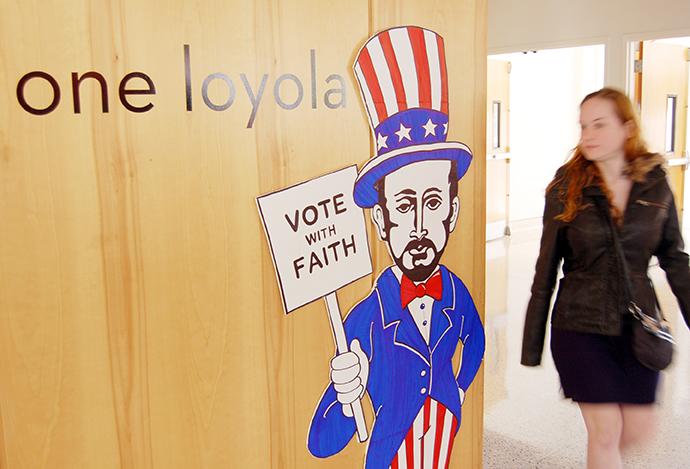 General studies freshmen Kate Watson looks at the voting sign displayed in the Danna Center. The sign “Vote With Faith” was made as a reminder to all faithful citizens to vote on Election Day.