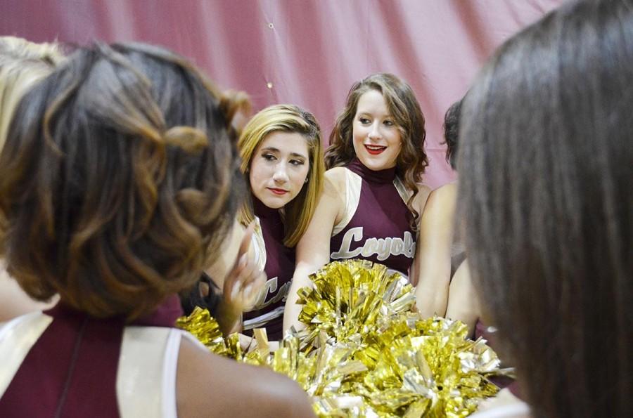 Dance team members psychology freshman Marigny Landry and music industry freshman Katie Hurst talk with teammates during a volleyball game last month. Seven dancers have quit since the semester started.