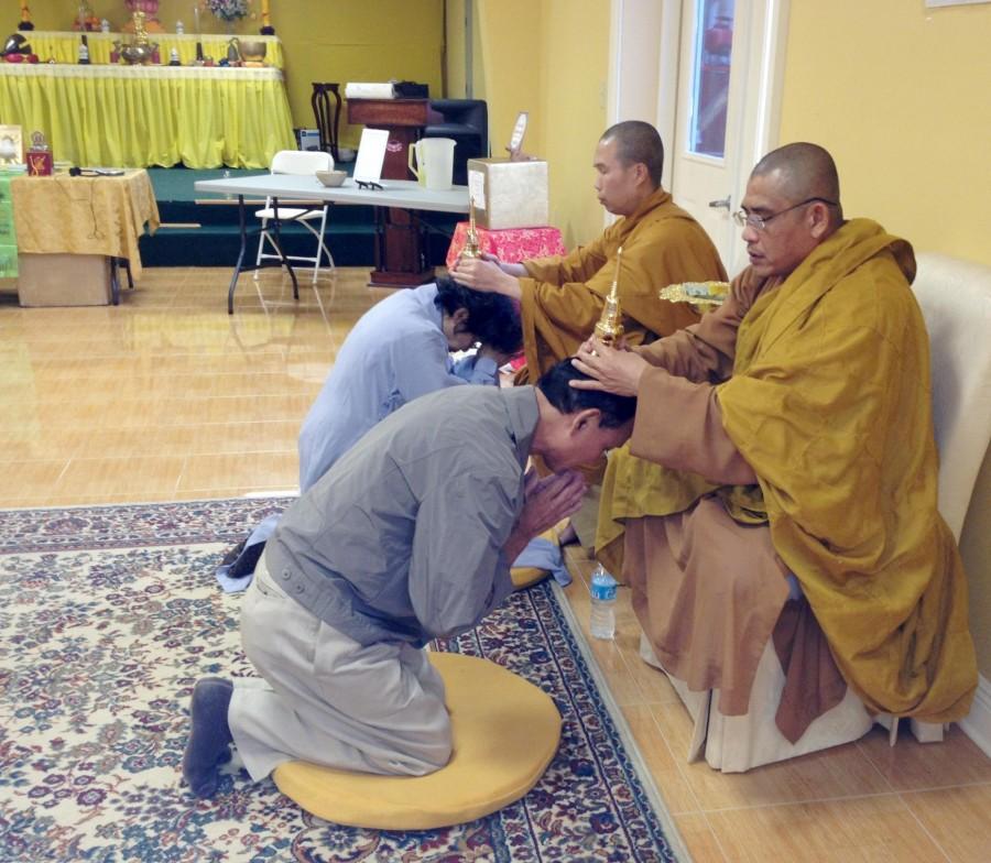 Buddhist monks place sacred relics on Vietnamese community members’ heads as part of a blessing ceremony. Community members visited Lien Hoa Temple to pray to the Buddhist relics and request blessings from Nov. 2-4.