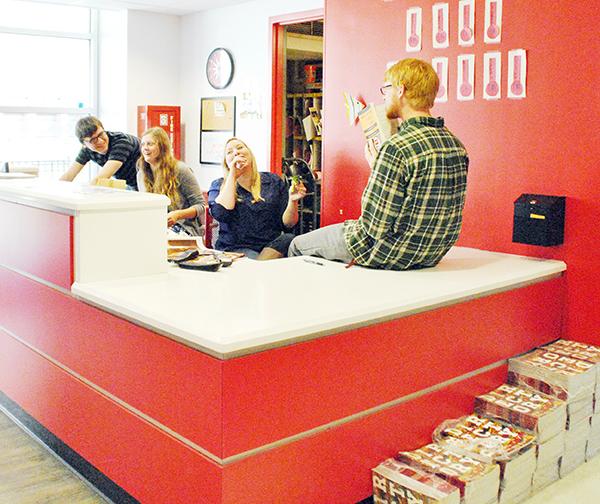 English sophomore Kyle Bonnet, physics sophomore Emily Reynolds, international business sophomore Bentlie Logan and economics sophomore Michael Olausen hang out at the lobby desk of Biever on Nov. 7. The directories still remain unpacked in Biever.