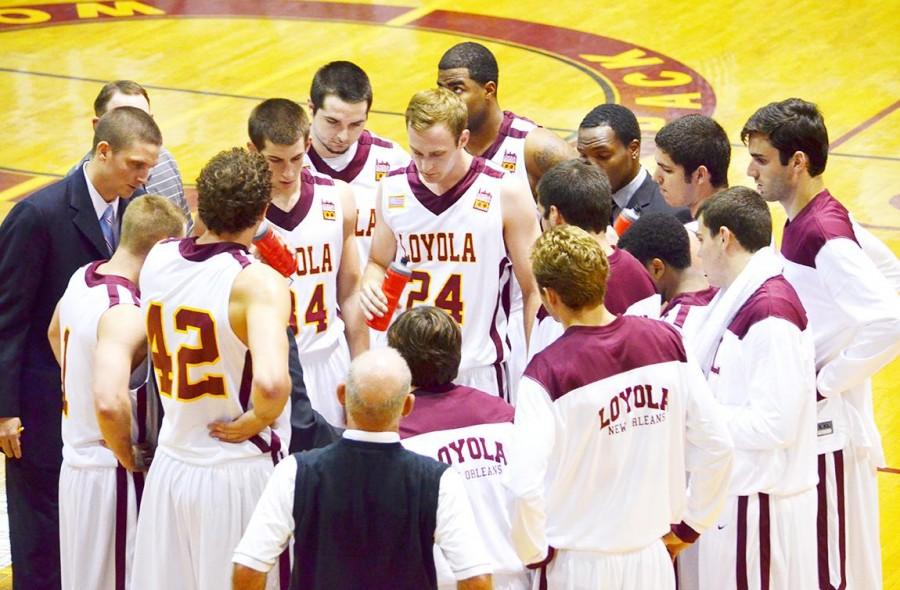 Finance junior MCall Tomeny, twenty four huddles with the Loyola basketball players during their game versus Morehouse College on Nov. 4. The Wolf Pack currently stands at 6-4 and will face Dillard of Dec. 9 and Southern University of New Orleans on Dec. 15.
