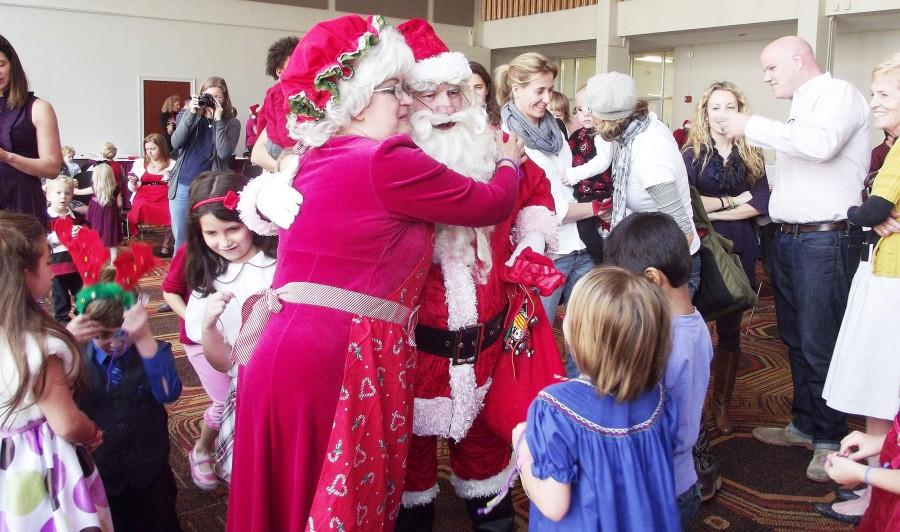 Mrs. Claus and Santa Claus embrace at the Singing with Santa event in the St. Charles room on Sunday, Dec. 2. Attendees played interactive games, watched a puppet show and sang carols.
