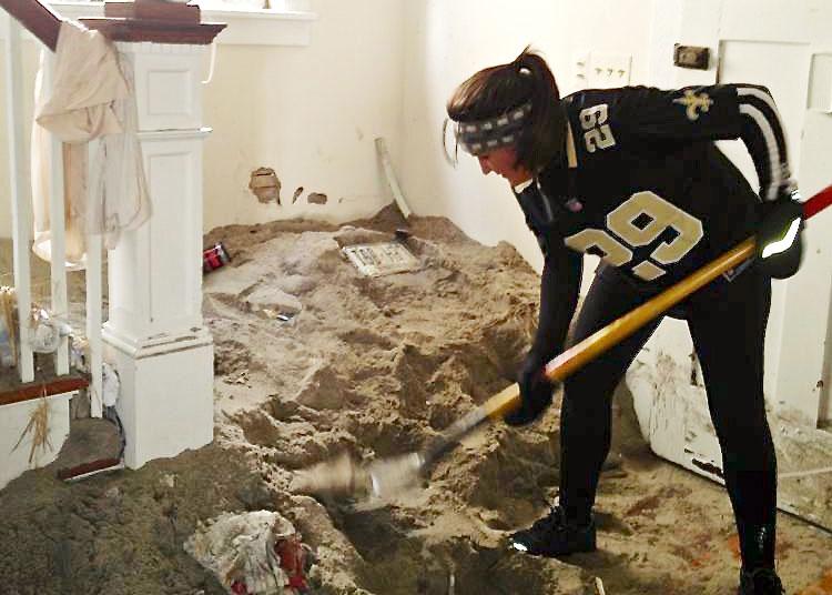 Colby Wilson shovels sand from a neighbor’s home in sea Bright, n.J. Wilson and 300 other volunteers have gone to different houses in the community to provide relief to many residents.