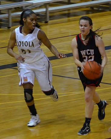 Sophomore Jeneicia Neely, 21, goes up against player from William Carey University in the game in The Den on Jan. 10. The Wolf Pack won the game with a score of 64-61.