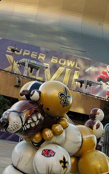 A statue of a dog decorated in Saints colors sits downtown. Super Bowl XLVII will take place in the Mercedes Benz Superdome and kicks off at 6