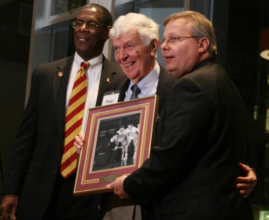 Assistant vice president for Student Affairs Robert Reed, left, and director of Athletics and Wellness and head basketball coach Michael Giorlando, right, pose for a photo with a Hall of Fame inductee. Distinguished Loyola athletes were inducted into the Loyola Hall of Fame on Saturday Jan. 19.