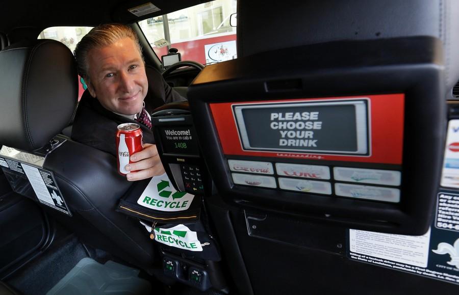 Simon Garber, owner of New Orleans Carriage Cab, poses inside a taxi cab with a backseat vending machine in New Orleans, Tuesday, March 19. New Orleans Carriage Cab launched backseat vending machines inside its 250-car fleet that also includes the Yellow-Checker Cab brands. 