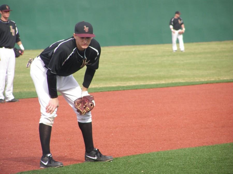 Loyola baseball players look on during a game verses Belhaven University on March 9. Though they are well into the season, the team continues to fit players into various positions on the field to build the most effective team.