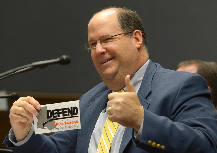 Rep. Jeff Thompson, R-Bossier City, holds up a sticker in response to questioning by Rep. Barbara Norton, D-Shreveport, during the House Criminal Justice Committee's discussion of House Bill 8 on Wednesday, April 17, at the Louisiana State Capitol in Baton Rouge