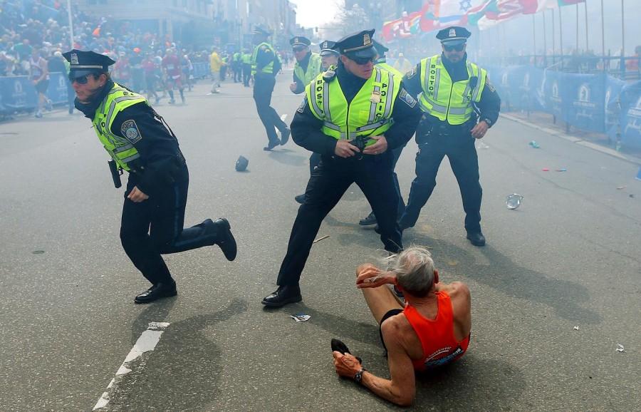 Police officers run towards an explosion during the Boston Marathon on April 15. The attack left three dead and over 100 injured. 