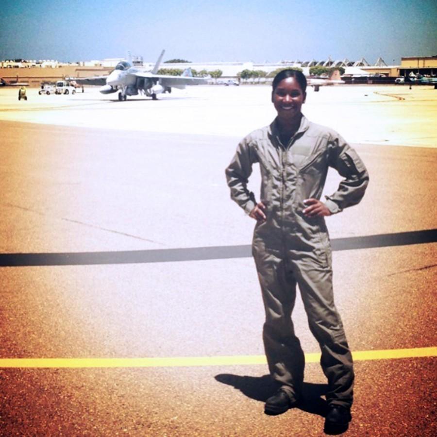  LaMicha Jackson poses on an aircraft runway. She wore this uniform regularly while interning for the Navy this summer.