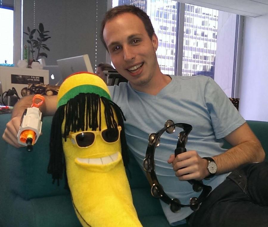 Bryan Mooney sits alongside a stuffed banana. This became a mascot for him and his MTV co-workers as they worked on their web show.