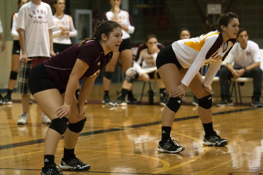 (Left to right) Environmental business junior and libero Becca Burnett and general studies business sophomore and outside hitter Katie Hamilton prepare to defend a serve in a game against Spring Hill College last season. Loyola lost to Spring Hill in straight sets in this season’s match up. 