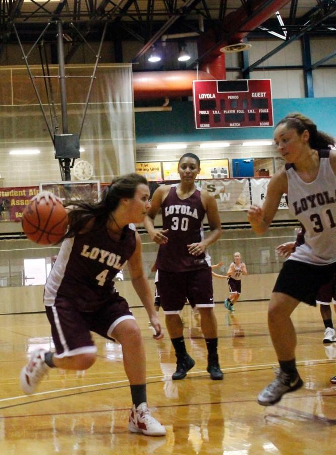 Accounting junior Megan Whittaker drives the lane at practicing with teammates Shayne Charles chemestry junior (30) and biology freshman Jackie Anderson (31) . Whittaker will play for Loyola this season  after playing two seasons with the Louisiana at Lafayette.