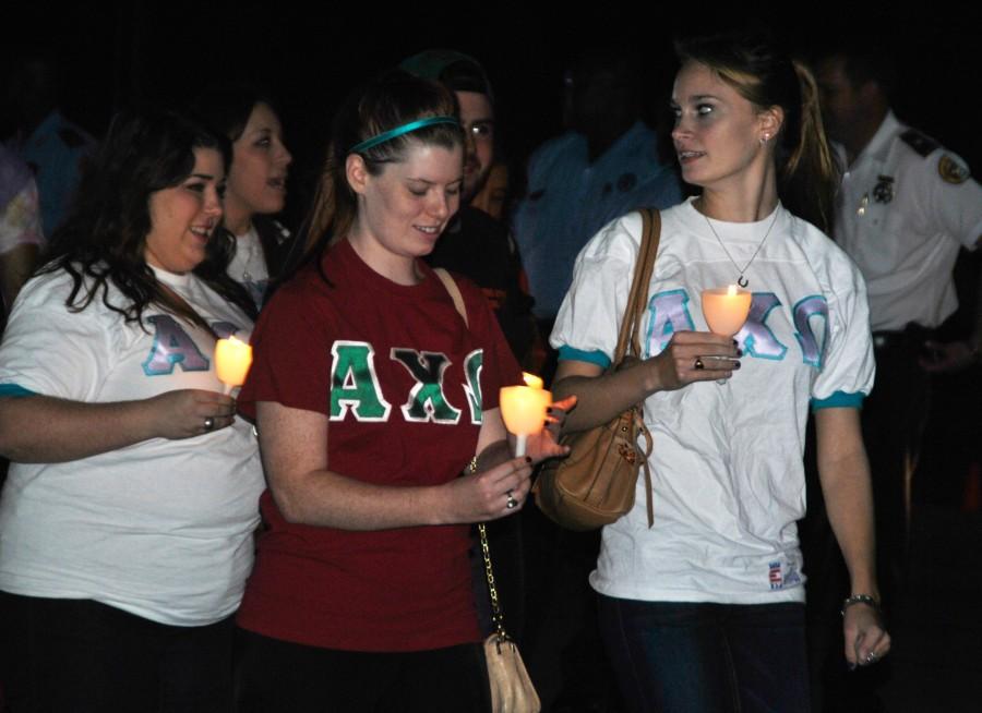(Left to right) Psychology sophomore Michaela Krummel, biology freshman Devin Bogle and economics sopohmore Megan McAndrews join in the candlelit march for Take Back the Night. Take Back the Night encouraged dialogue about sexual violence and sexual shame in the New Orleans community.