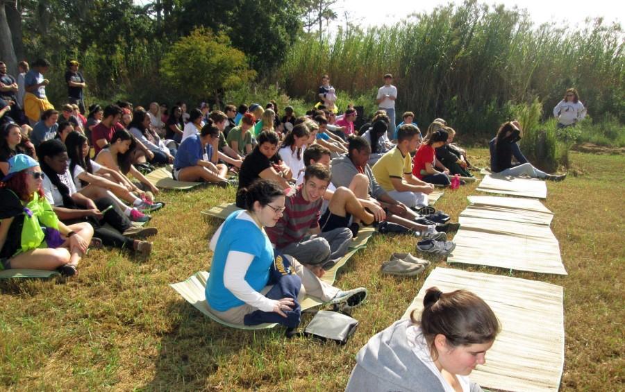 Students await instruction after arriving at Fountainbleau State Park in Mandeville, La., for the biannual Awakening retreat. The retreat had undergone several changes after the threat of a tropical storm led to it being postponed in the interest of safety.