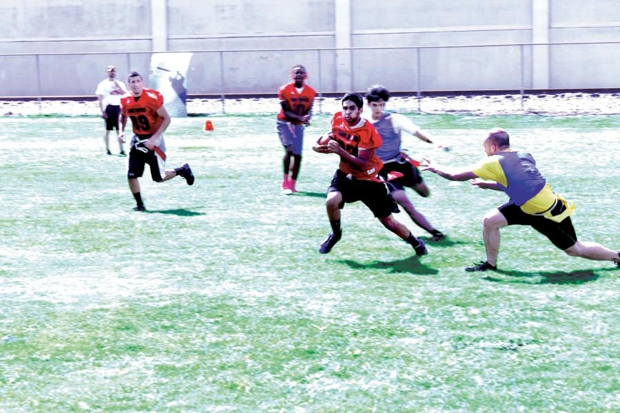 A player for the Swipers avoids a tackle during a flag football game at St. Patrick’s field. Flag football is one of nine intramural sports Loyola is offering in the fall semester. 