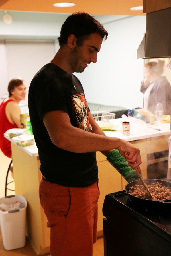 Business management sophomore Alex Asdourian cooks a meal in his Cabra Hall suite. For those who stay behind for Thanksgiving, cooking a meal with friends is a way to celebrate the holiday.