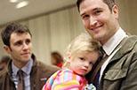 Nicholas Van Sickle (right) stands with his husband, Andrew Bond, and holds their 2-year-old adopted daughter, Jules, before a news conference in New Orleans about a federal lawsuit filed on Feb. 12.
