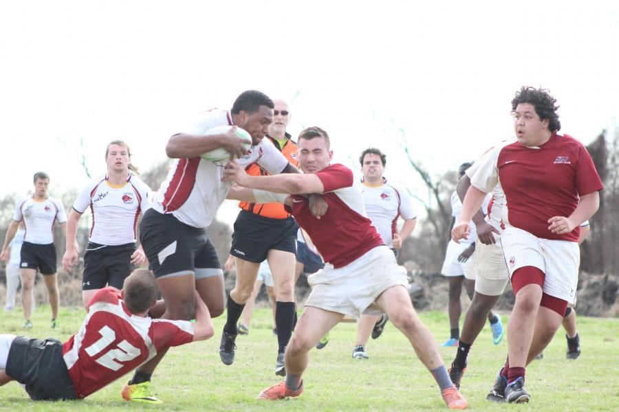 Shawn Maheia blocks a tackle against a defender from Southern Illinois. They won the weekend tournament put on by the New Orleans Rugby Football Club. The team travels to Florida for the second round of the tournament.