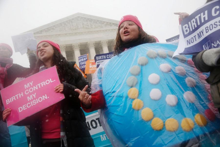 Margot Riphagen (Right) of New Orleans, wears a birth control pills costume as she protests in front of the Supreme Court in Washington D.C. on March 25. The court heard arguments in the challenges of President Obama’s health care law requirement that businesses provide their female employees with health insurance that includes access to contraceptives. 
