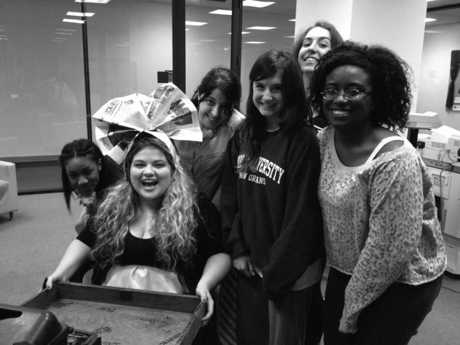 Aaren Gordon signs the editor-in-chief’s desk while surrounded by her staff. Signing the desk is one of many traditions for The Maroon’s editor-in-chief.