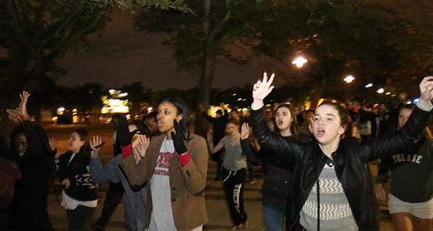Protestors march through the campus area chanting.