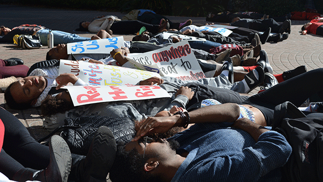 Students gather for a die-in protest around the Iggy statue December 9.
